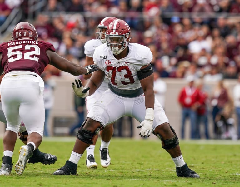 Alabama offensive tackle Evan Neal stands with NFL Commissioner