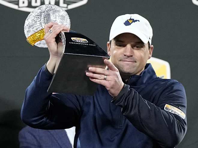 Texas has hired former West Virginia coach Neal Brown