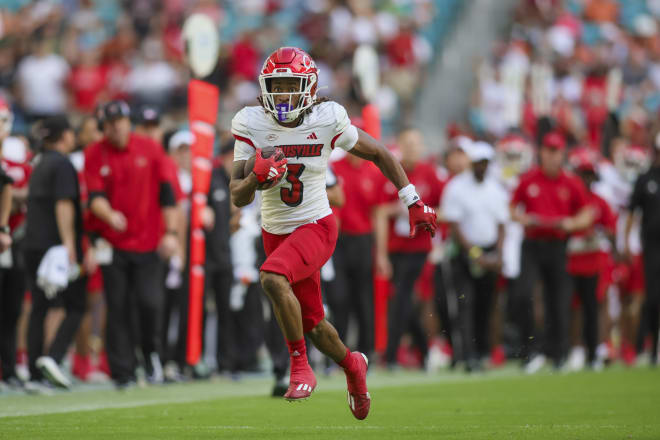 Nov 18, 2023; Miami Gardens, Florida, USA; Louisville Cardinals wide receiver Kevin Coleman (3) runs with the football for a touchdown against the Miami Hurricanes during the fourth quarter at Hard Rock Stadium.