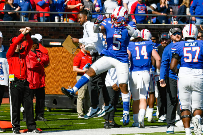 Samples, in 2019, celebrating with running back Xavier Jones.