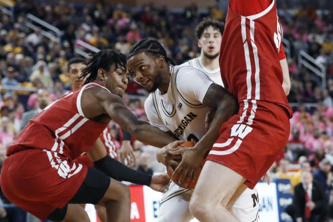 Michigan guard Zavier Simpson (3) workds between Wisconsin forwards Aleem Ford, left, and Nate Reuvers during the second half in Ann Arbor, Mich