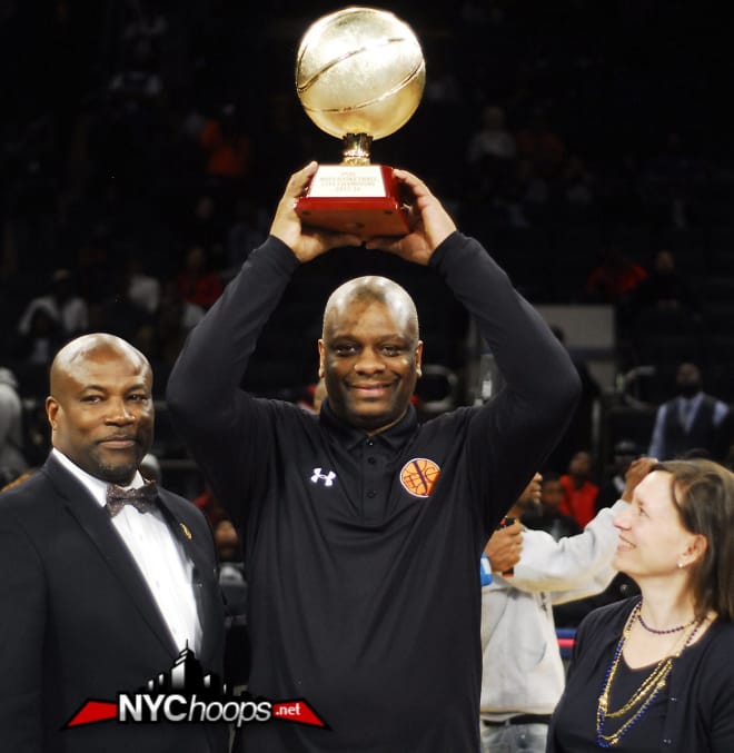 Jefferson Head Coach Lawrence Pollard holds up PSAL City Championship, 54 years in the making