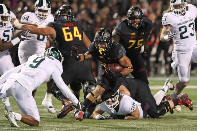 Lorenzo Harrison (center) makes a defender miss in the Terps' win over MIchigan State.