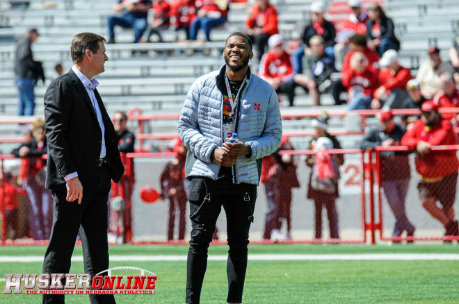 NU AD Trev Alberts talks with Ochaun Mathis before the spring game.