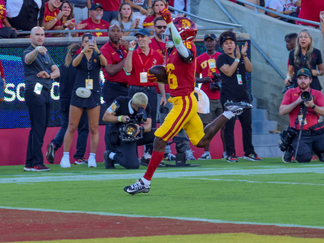 Tahj Washington runs into the end zone on his 76-yard touchdown catch Saturday.