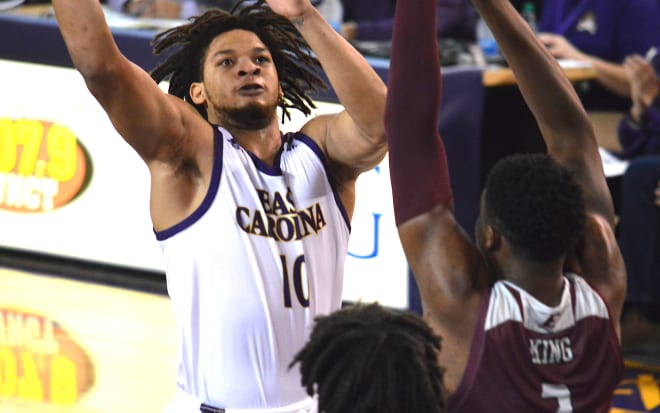 Tyree Jackson drives in the paint against Eastern Kentucky's Tre King in ECU's fourth straight win on Saturday.