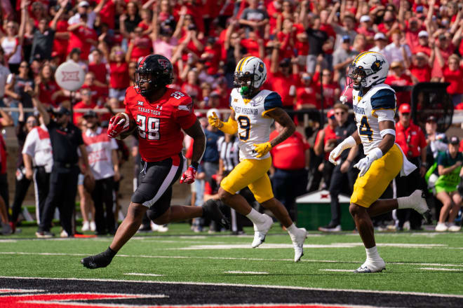 Tahj Brooks runs into the end zone during Texas Tech's 48-10 win over West Virginia on Saturday.