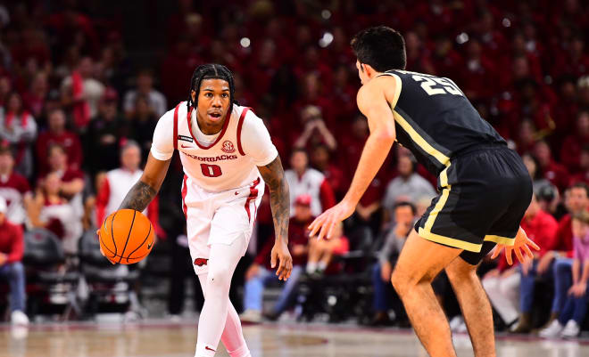 Arkansas guard Khalif Battle dribbles with Purdue's Ethan Morton guarding him in Saturday's exhibition at Bud Walton Arena.