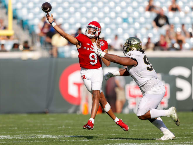 Dec 31, 2021; Jacksonville, Florida, USA; Rutgers Scarlet Knights quarterback Gavin Wimsatt (9) throws a pass while pressured by Wake Forest Demon Deacons defensive lineman Dion Bergan Jr. (95) in the second half at TIAA Bank Field.