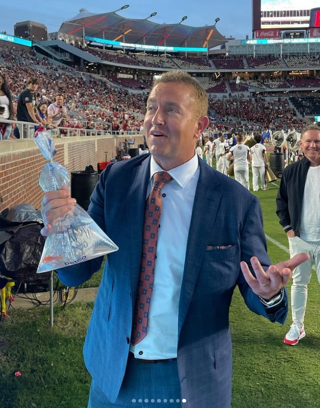 ESPN broadcaster Kirk Herbstreit is one of quite a few FSU and college football celebrities who have taken pictures with Garnet the Goldfish.