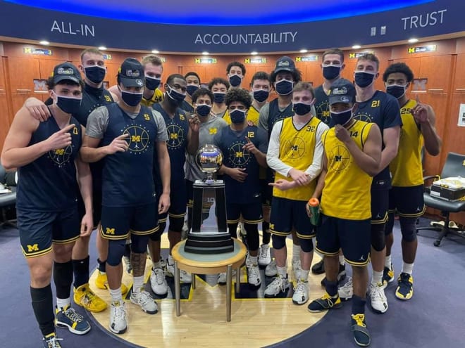 The Michigan Wolverines basketball Big Ten champions with their trophy. 