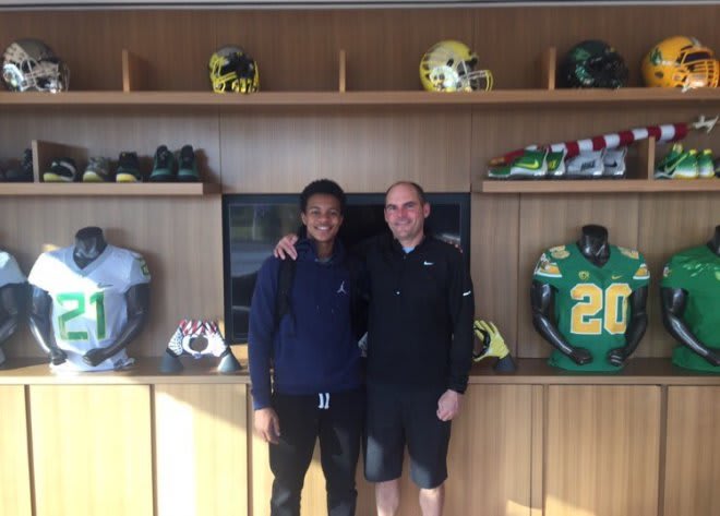 Douglas (left) committed Oregon and head coach Mark Helfrich (right) July 17, but is exploring his options after Helfrich was let go following a 4-8 season for the Ducks.