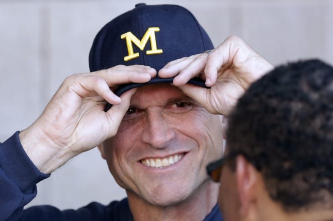 Michigan Wolverines football coach Jim Harbaugh and his staff are implementing schemes early in spring ball.