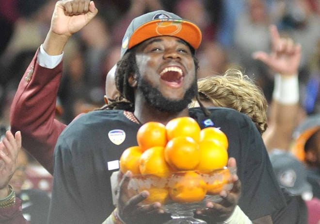 Florida State tailback Dalvin Cook celebrates with the Orange Bowl trophy after his team's 33-32 win over Michigan.