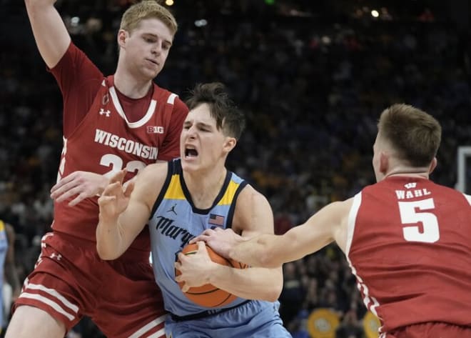 Marquette's Tyler Kolek tries to drive past Wisconsin's Steven Crowl and Tyler Wahl in the Badgers' 80-77 overtime victory.