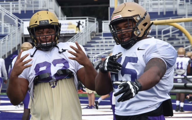 James Madison defensive tackles Mike Greene, left, and Adeeb Atariwa stop for a photo during Dukes practice earlier this month at Bridgeforth Stadium.