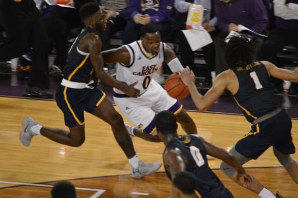 Issac Fleming drives for two of his 14 points in ECU's 75-50 opening night win over Coppin State.