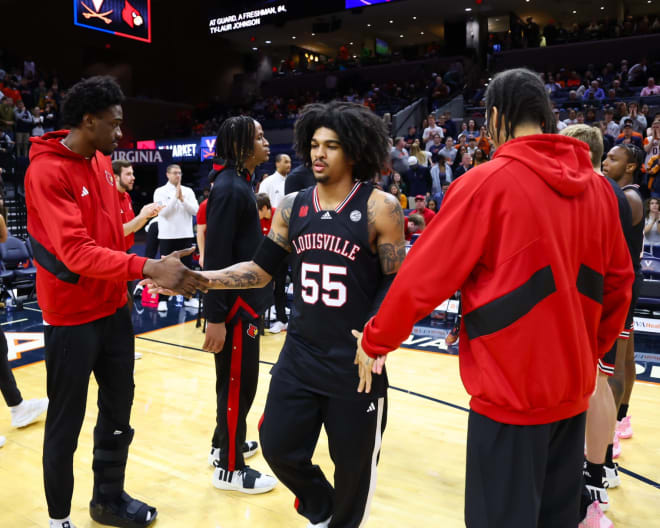 Skyy Clark (55) daps his teammates up during player introductions. Photo via Louisville Men’s Basketball (X).