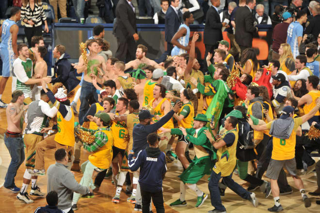Notre Dame students storm the court after the 80-76 comeback win versus No. 2 North Carolina.