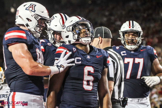 Michael Wiley celebrates with his teammates after scoring a touchdown in Saturday's win for Arizona over UTEP.