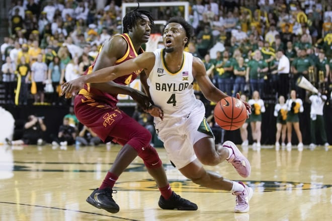 Mar 4, 2023; Waco, Texas, USA; Baylor Bears guard LJ Cryer (4) dribbles around Iowa State Cyclones guard Demarion Watson (4) during the second half at Ferrell Center.