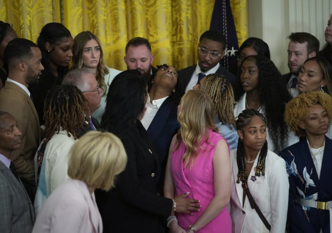 LSU' forward Sa'Myah Smith passes out while standing with teammates in the East Room of the White House Friday afternoon as President Joe Biden and First Lady Jill Biden celebrated the NCAA champion Lady Tigers 