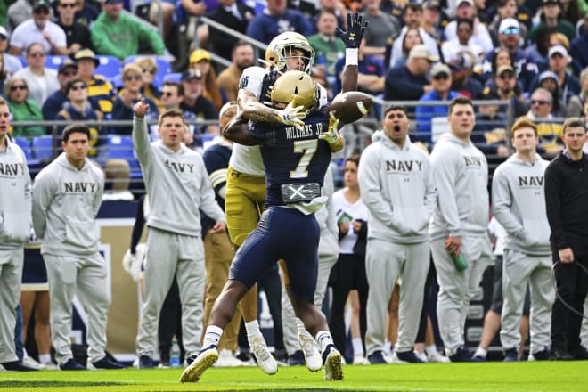 Notre Dame wide receiver Braden Lenzy catches a TD pass off the back of Navy cornerback Mbiti Williams Jr.