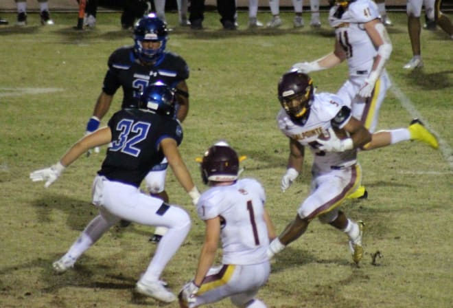 Salpointe running back Bijan Robinson gains some yards as Chandler linebacker Tate Romney (32) closes in. Last month marked the first time 4A teams met 6A ones in the playoffs. 