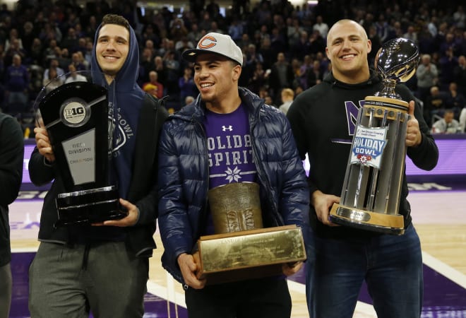 Isaiah Bowser (middle) holds one of three trophies Northwestern claimed following their successful 2018 season.
