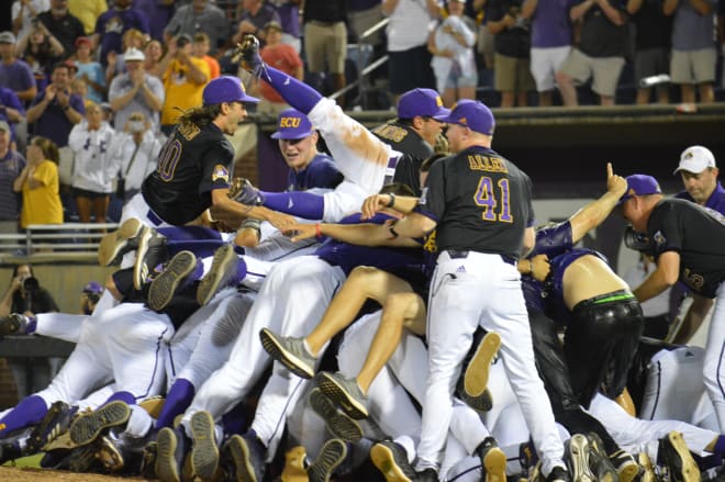 ECU players dog pile after 12-3 win over Campbell to win the NCAA Greenville Regional title Monday night.
