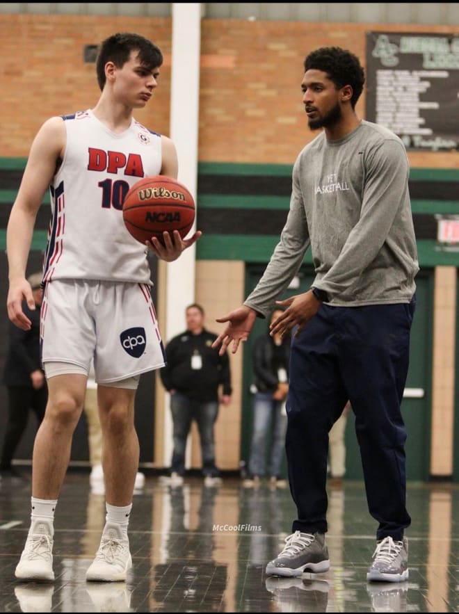 Dom Collier, an assistant coach at Denver Prep Academy, speaks with DPA guard Juanse Gorosito during a recent Grind Session game vs. Donda Academy 