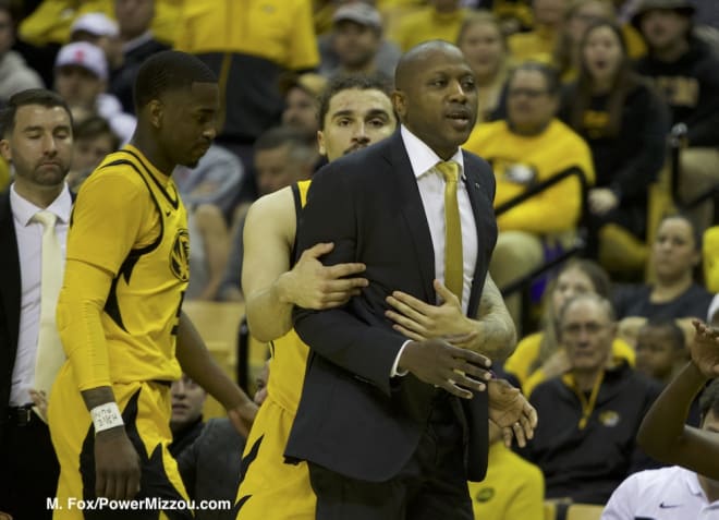 Tre Gomillion holds Dennis Gates back in the second half of Mizzou's 79-76 win