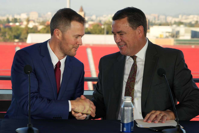 New USC football coach Lincoln Riley shakes hands with athletic director Mike Bohn at a press conference in the Coliseum two Mondays ago.
