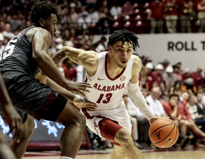 Alabama Crimson Tide guard Jahvon Quinerly (13) dribbles around Texas A&M Aggies forward Henry Coleman III (15) during the second half at Coleman Coliseum. Photo |  Butch Dill-USA TODAY Sports
