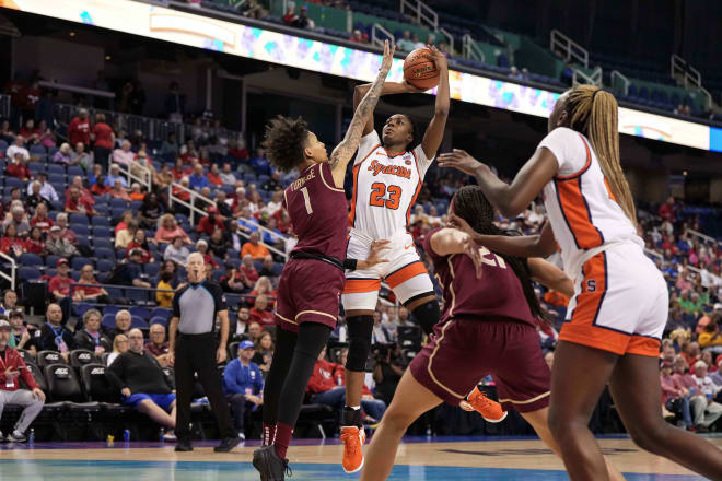 Mar 8, 2024; Greensboro, NC, USA; Syracuse Orange forward Alyssa Latham (23) shoots the ball over Florida State Seminoles guard Brianna Turnage (1) in the first half at Greensboro Coliseum.