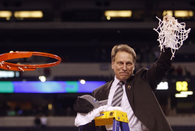 Michigan State Spartans coach Tom Izzo waves to the crowd after cutting down the net after defeating the Louisville Cardinals 64-52 in the finals of the midwest region of the 2009 NCAA mens basketball tournament at Lucas Oil Stadium.