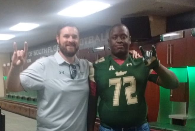 Coach Mattox and Marcellus poses in the locker room