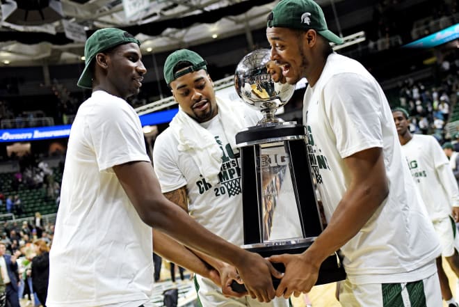 Michigan State's Jaren Jackson Jr., Nick Ward, and Xavier Tillman carry the BIG 10 Conference championship trophy back to the locker room after the game on Tuesday, Feb. 20, 2018, at the Breslin Center in East Lansing. (Nick King/Lansing State Journal)