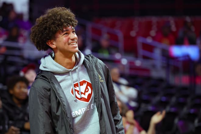 St. Elizabeth High School guard Aiden Tobiason, who signed with Temple earlier this month, smiles while taking in Saturday's game. 