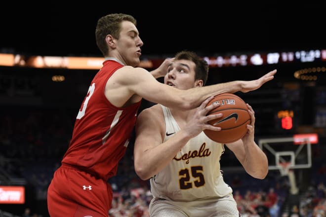 Loyola (IL) Ramblers center Cameron Krutwig (25) looks to score against a Bradley defender during the second half of the 2019 Missouri Valley Conference Tournament at Enterprise Center. 