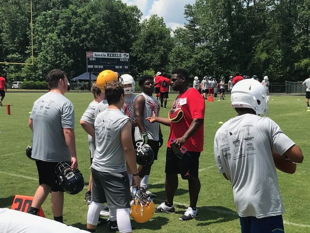 Geno Atkins coaches some youngsters during Saturday's Brandon Wood camp.
