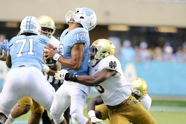 Tar Heels QB Chazz Surratt was under a constant avalanche of pressure, including 11 hurries. Here, Nyles Morgan does the honors for the Irish.