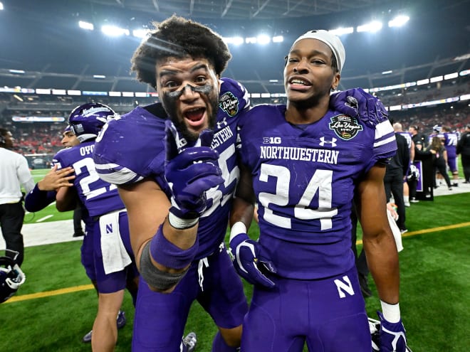 Northwestern linebacker Kenny Soares Jr., front left, and defensive back Rod Heard II celebrate in the final seconds of the Las Vegas Bowl in December.