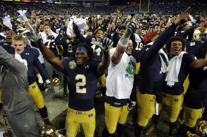 Notre Dame players celebrate 2014 Music City Bowl win over LSU to end a four-game losing streak. 