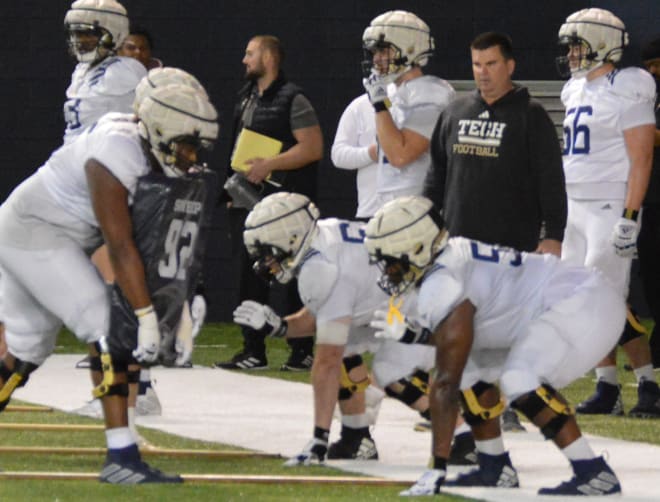 Tech offensive linemen prepare to block last week while Geep Wade watches.