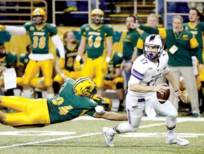 JMU quarterback Bryan Schor escapes pressure during the Dukes' semifinal win at North Dakota State on Dec. 16 in Fargo, N.D.