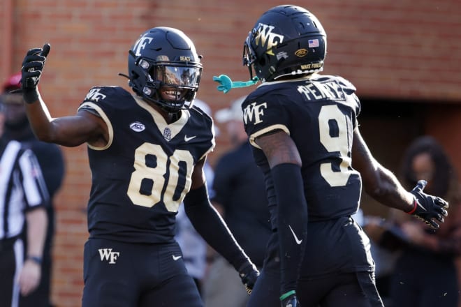 A.T. Perry, right, celebrates with teammate Jahmal Banks during a game last season. 
