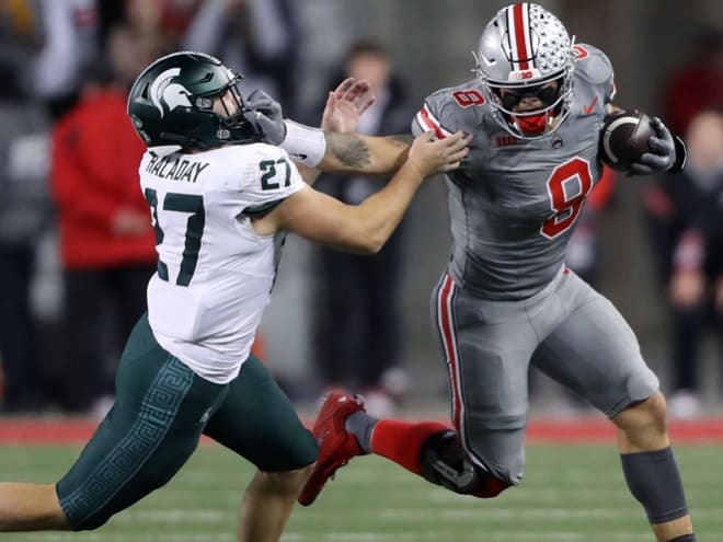 Ohio State Buckeyes tight end Cade Stover (8) catches the football as Michigan State Spartans linebacker Cal Haladay (27) makes the tackle during the first quarter at Ohio Stadium. 