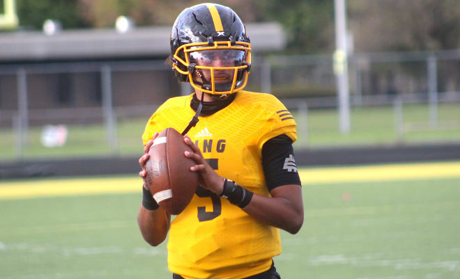 Detroit quarterback Dante Moore holds a Michigan Wolverines football recruiting offer. 