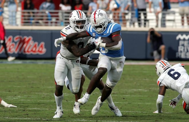 Owen Pappoe tackles an Ole Miss player.